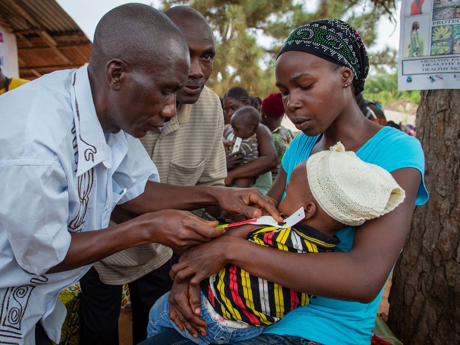 A mother in Africa receiving aid with her baby