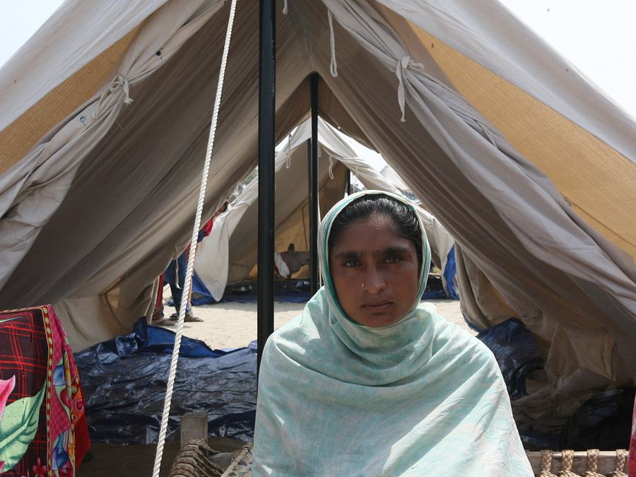 A woman in front of a shelter tent
