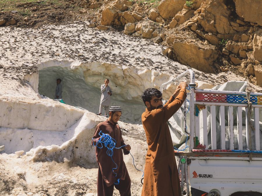 People carrying heating fuel along a snowy road