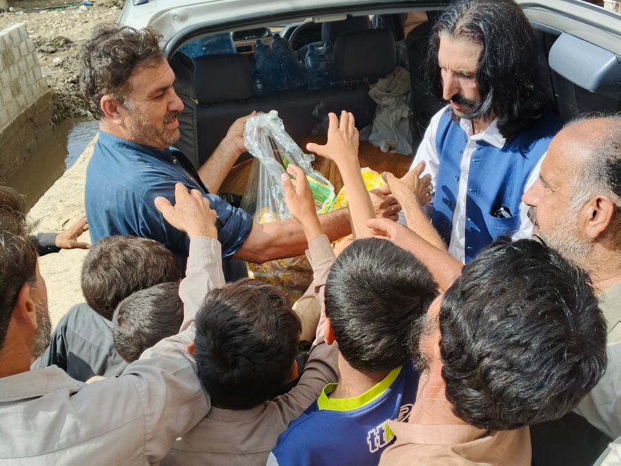 Hands reaching for an aid pack